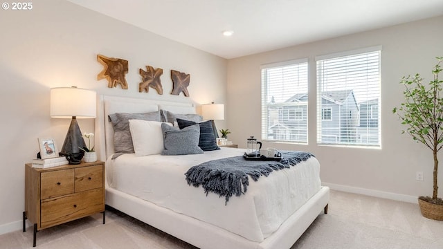 bedroom featuring baseboards, multiple windows, and light carpet
