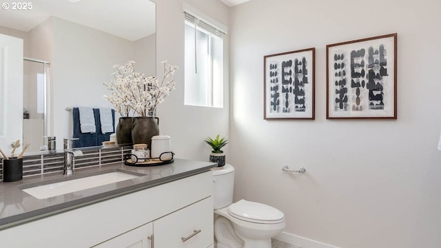 full bathroom featuring vanity, an enclosed shower, and toilet