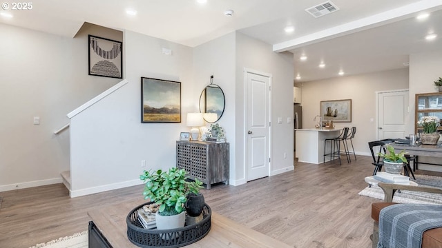 living room featuring visible vents, recessed lighting, and light wood-style floors