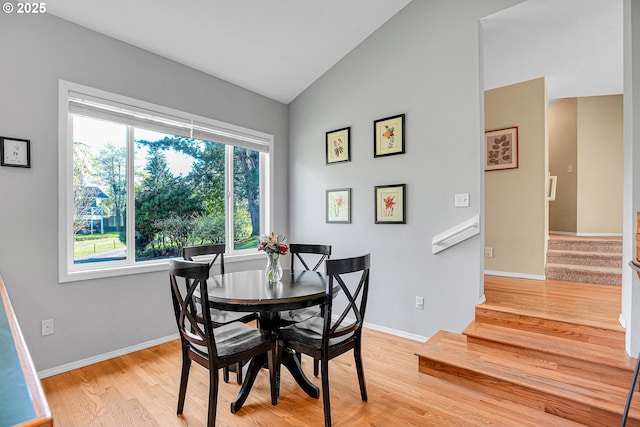 1223 NE 160th Ave, Portland, OR 97230 - dining space featuring stairway, baseboards, vaulted ceiling, and light wood-style flooring