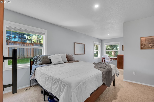 1223 NE 160th Ave, Portland, OR 97230 - bedroom with a textured ceiling, multiple windows, and light carpet