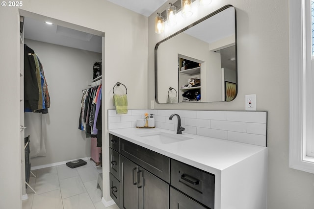 1223 NE 160th Ave, Portland, OR 97230 - bathroom featuring decorative backsplash, vanity, baseboards, marble finish floor, and a spacious closet