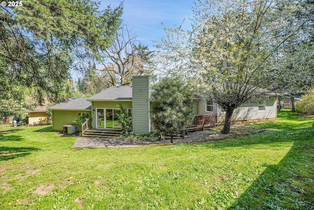 1223 NE 160th Ave, Portland, OR 97230 - rear view of property with a lawn, a wooden deck, a chimney, and central AC unit