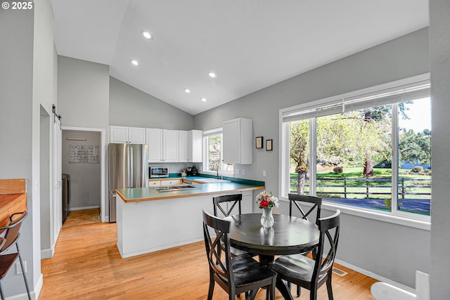 1223 NE 160th Ave, Portland, OR 97230 - dining area with a barn door, light wood-style floors, recessed lighting, baseboards, and visible vents