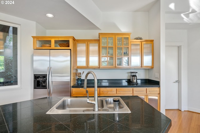 kitchen with stainless steel fridge, sink, and light wood-type flooring