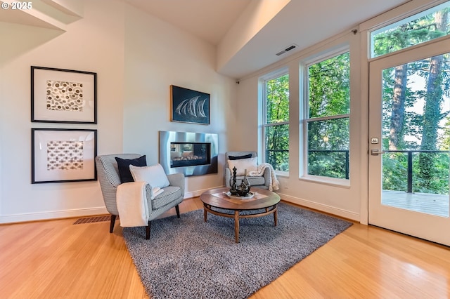 4300 SW Hewett Blvd, Portland, OR 97221 - sitting room with wood finished floors and a multi sided fireplace