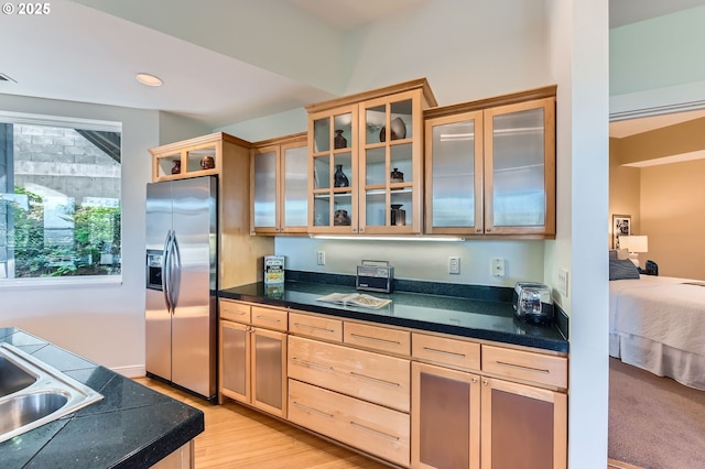 4300 SW Hewett Blvd, Portland, OR 97221 - kitchen featuring stainless steel fridge, light wood-style floors, light brown cabinets, glass insert cabinets, and recessed lighting