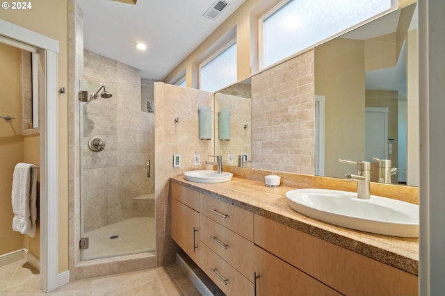 bathroom with vanity, tile patterned floors, and a shower with shower door