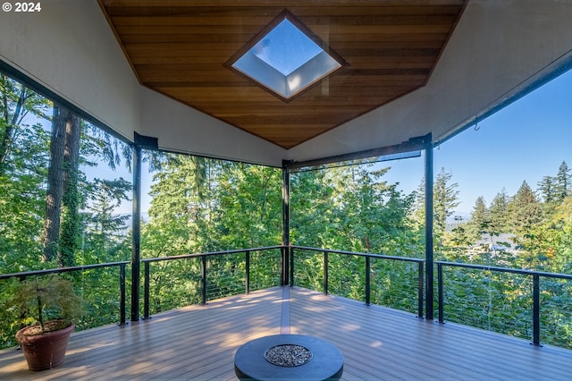 wooden terrace featuring an outdoor fire pit