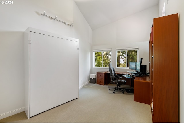 office with high vaulted ceiling and light carpet