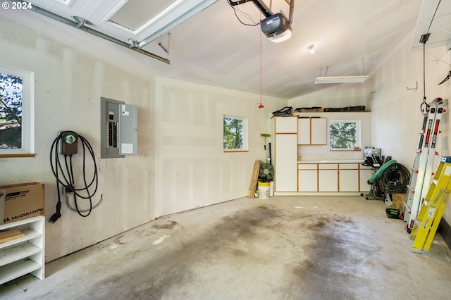 garage with a garage door opener and electric panel