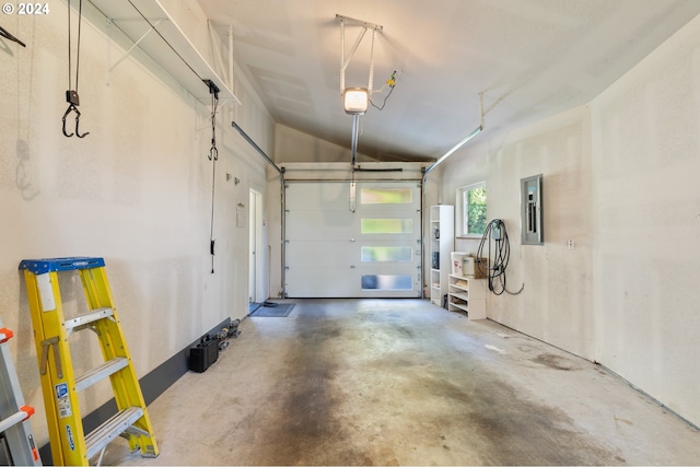 garage with a garage door opener and electric panel