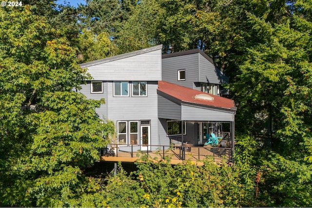 back of property featuring a deck