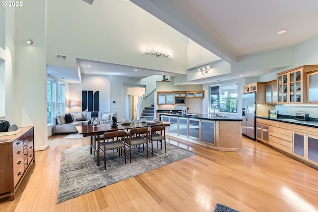 4300 SW Hewett Blvd, Portland, OR 97221 - dining room with stairs, light wood finished floors, and a high ceiling
