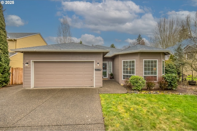 single story home with an attached garage, a shingled roof, fence, driveway, and a front yard