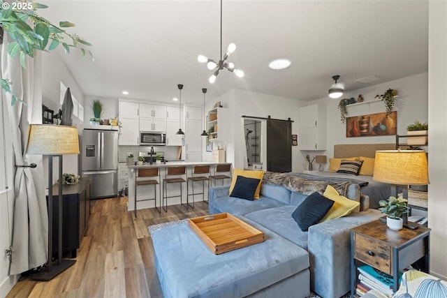 720 S 19th Pl, Ridgefield, WA 98642 - living area with a barn door, wood finished floors, recessed lighting, and a chandelier