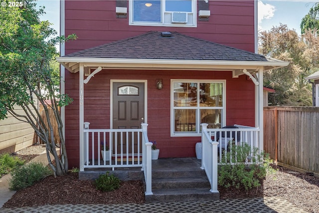 1106 Wilson St, Hood River, OR 97031 - doorway to property featuring a shingled roof, covered porch, and cooling unit