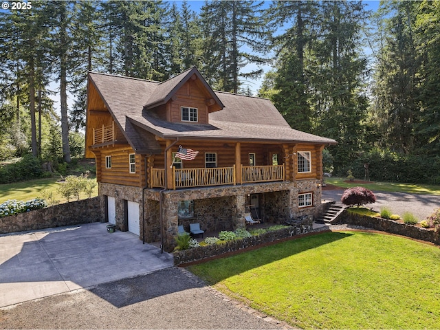 93011 Labeck Rd, Astoria, OR 97103 - log cabin featuring log exterior, concrete driveway, a front lawn, a garage, and stone siding