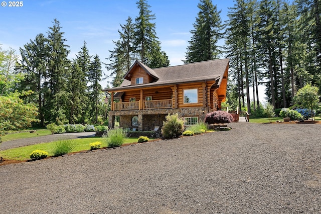93011 Labeck Rd, Astoria, OR 97103 - cabin featuring log siding, gravel driveway, a balcony, and stone siding