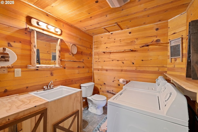 93011 Labeck Rd, Astoria, OR 97103 - washroom featuring independent washer and dryer, wood walls, and wood ceiling