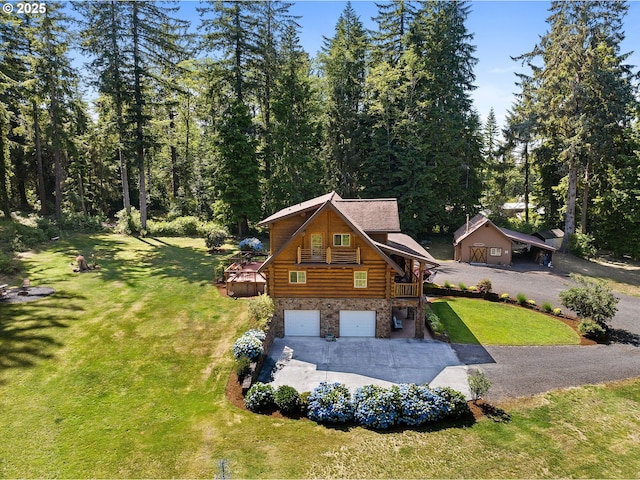 93011 Labeck Rd, Astoria, OR 97103 - view of property exterior with log siding, concrete driveway, an attached garage, a yard, and stone siding
