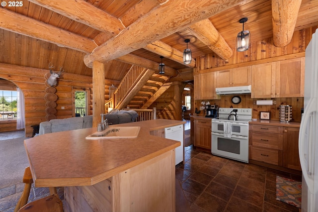 93011 Labeck Rd, Astoria, OR 97103 - kitchen with white appliances, under cabinet range hood, open floor plan, a wood ceiling with exposed beams, and rustic walls