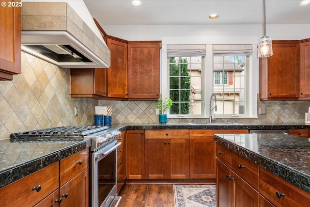 kitchen with high end stove, a sink, dark wood finished floors, tile countertops, and custom exhaust hood