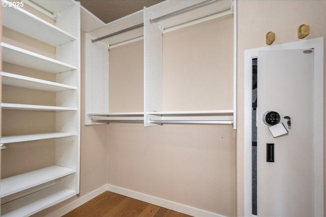 spacious closet with wood finished floors