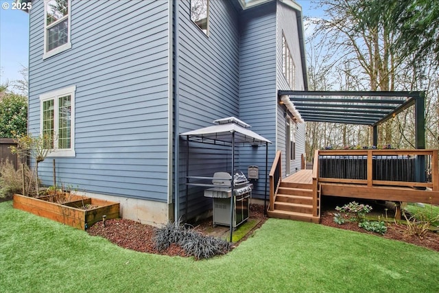 view of side of home with a garden, a yard, a deck, and a pergola