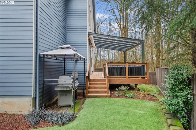 view of yard featuring a wooden deck and fence