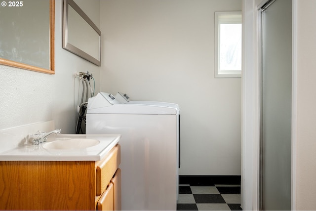 laundry area featuring washing machine and clothes dryer and sink