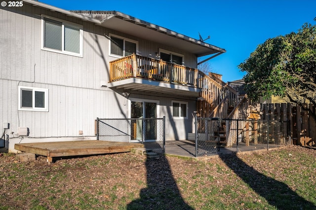 rear view of house with a balcony and a deck