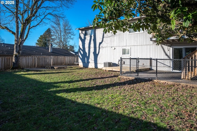 view of yard with cooling unit and a patio