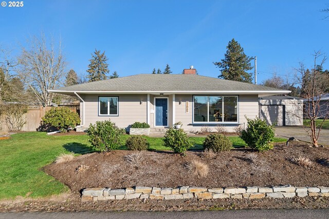 ranch-style house with a garage and a front lawn