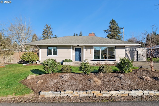 ranch-style home with a garage and a front lawn