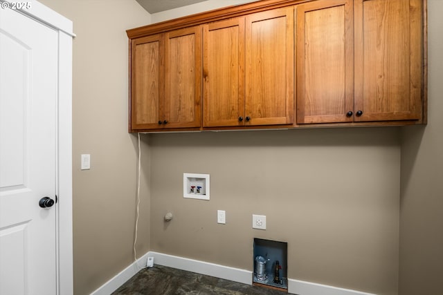 washroom with gas dryer hookup, hookup for an electric dryer, washer hookup, cabinet space, and baseboards