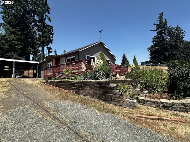 77668 Dugan Ln, Cottage Grove, OR 97424 - view of front facade with a carport, driveway, and a wooden deck