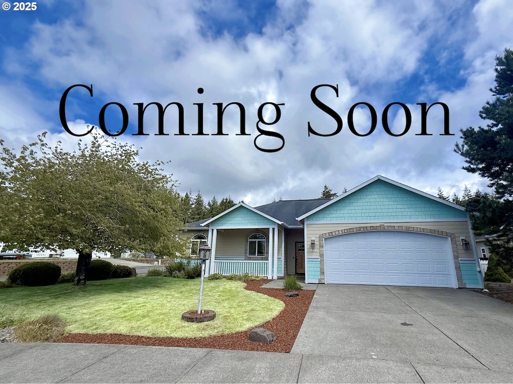1249 Zebrawood St, Florence, OR 97439 - view of front of home featuring a garage, a porch, a front yard, and concrete driveway