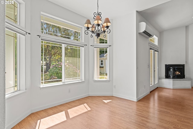 1249 Zebrawood St, Florence, OR 97439 - unfurnished dining area featuring a wall mounted air conditioner, healthy amount of natural light, and a chandelier