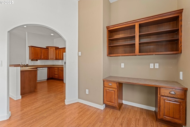 1249 Zebrawood St, Florence, OR 97439 - unfurnished office with built in desk, light wood-style floors, baseboards, arched walkways, and a sink