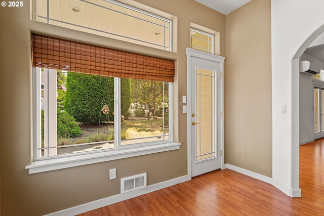 1249 Zebrawood St, Florence, OR 97439 - entrance foyer with arched walkways, baseboards, healthy amount of natural light, and wood finished floors