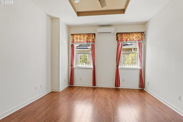 1249 Zebrawood St, Florence, OR 97439 - empty room with a wall mounted AC, plenty of natural light, wood finished floors, and ceiling fan