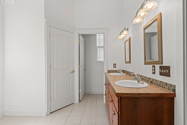 1249 Zebrawood St, Florence, OR 97439 - full bath featuring double vanity, tile patterned flooring, baseboards, and backsplash