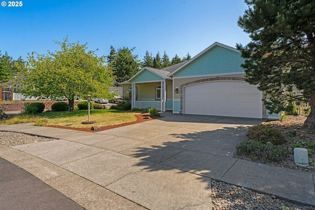 1249 Zebrawood St, Florence, OR 97439 - view of front of home with a porch, an attached garage, a front lawn, and concrete driveway