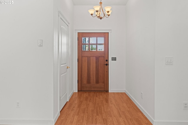 1249 Zebrawood St, Florence, OR 97439 - entryway with a chandelier, light wood finished floors, and baseboards