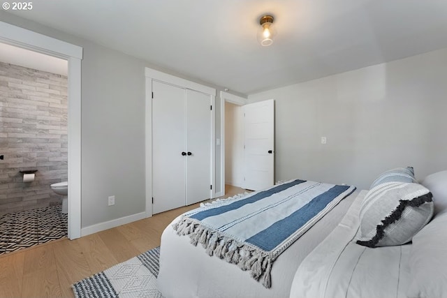 4038 NE Multnomah St, Portland, OR 97232 - bedroom featuring wood finished floors, a closet, and ensuite bathroom