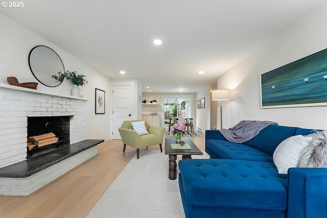 4038 NE Multnomah St, Portland, OR 97232 - living room with wood finished floors, a brick fireplace, and recessed lighting