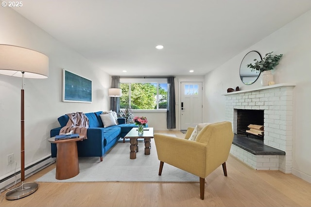 4038 NE Multnomah St, Portland, OR 97232 - living room featuring wood finished floors, a brick fireplace, recessed lighting, and a baseboard heating unit