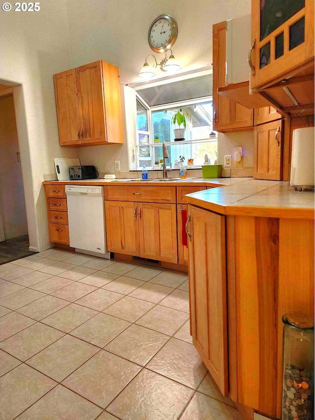 100 Canyon View St, Canyonville, OR 97417 - kitchen featuring white dishwasher, a peninsula, a sink, light tile patterned flooring, and tile countertops