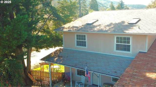 view of side of home with fence